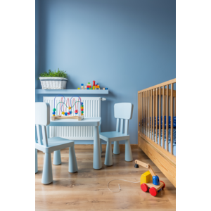 Blue baby room with floor panels, cot and small blue table and chairs | © .